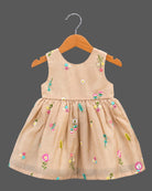 Toddler hand-embroidered sleeveless frock featuring a gathered empire silhouette and scattered floral details