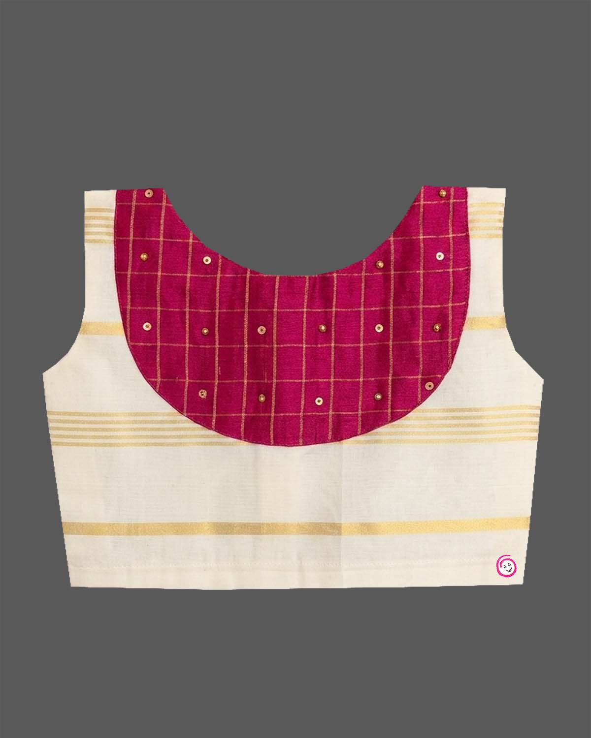A sleeveless top with a checkered patch and a gold-striped skirt for Onam traditional wear.