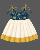 Young princess wearing shoulder tie-up brocade yoke frock with Kasavu pleated skirt for Onam