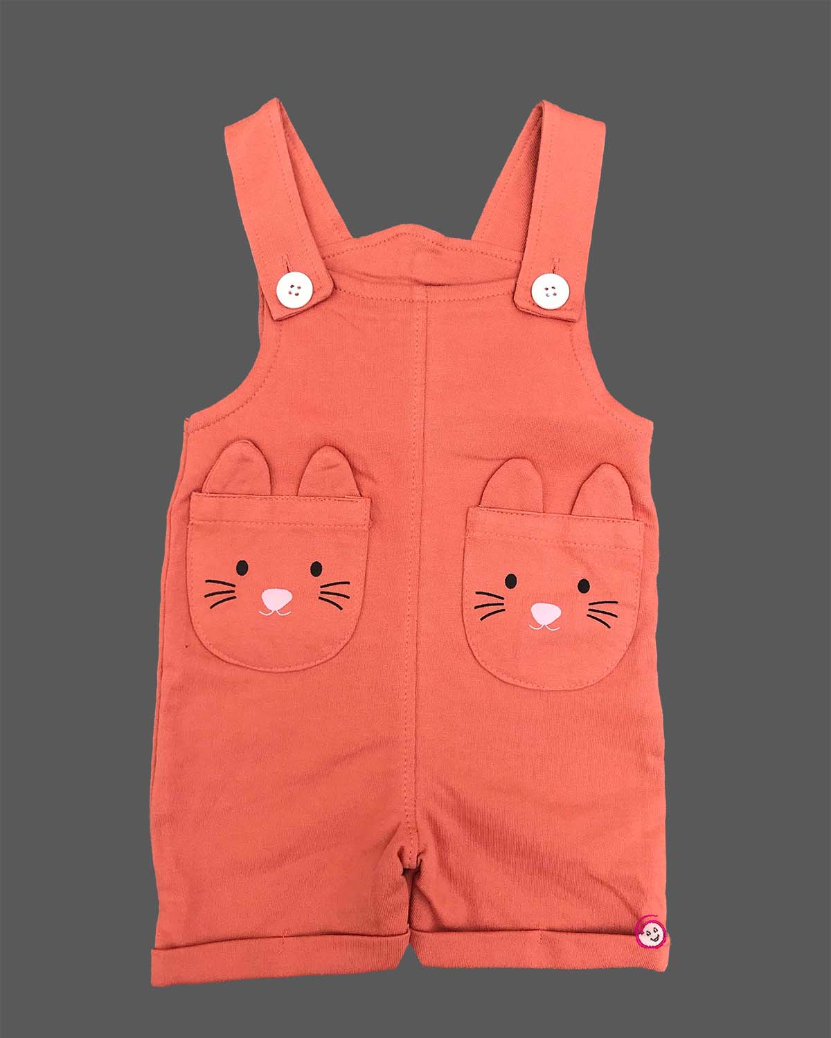 Little boy wearing cute character pocket dungaree shorts with soft solid t-shirt.