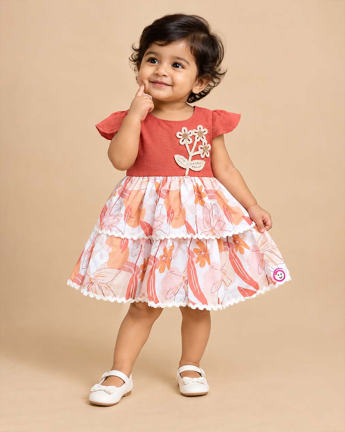 Little girl tiered printed casual frock with cap sleeves and floral crochet applique