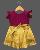 Detailed front view of a baby girl's luxury cotton silk frock with exquisite hand-embroidered neckline, ruffled sleeves, and a heavy woven zari pattu border for festive wear.