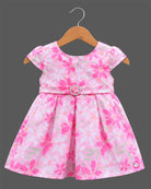 Girls floral box pleated frock with cap sleeves, round neck, and embellished buckle waist belt.