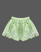 Sleeveless ruffle strap top paired with a flared embroidered skirt for a young fashionista.