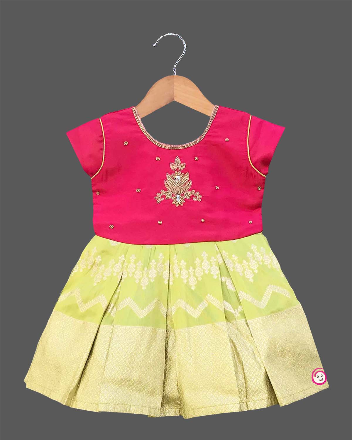 Infant cotton silk frock in magenta and lime green with traditional gold zari border and center motif embroidery for temple visits, festivals, and family functions