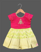 Infant cotton silk frock in magenta and lime green with traditional gold zari border and center motif embroidery for temple visits, festivals, and family functions