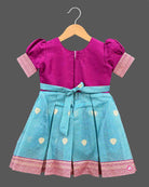 Embroidered pattu frock for baby girl with puffed sleeves, zari border, and box-pleated silhouette.