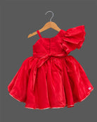 Girls sequin one shoulder frock with dramatic ruffle sleeve, floral waist applique, and flared layered skirt.
