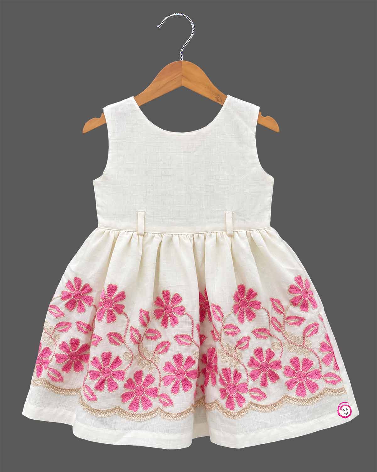 Little girl off-white and pink floral embroidered cotton dress paired with a cropped pink short sleeve jacket