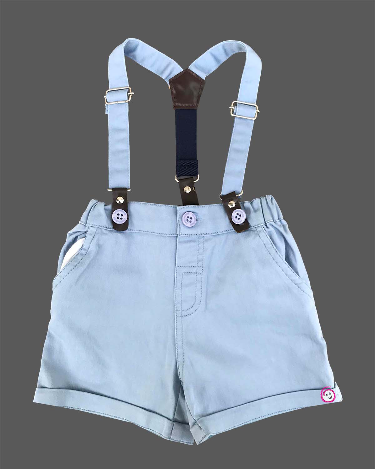 Stylish young boy's printed shirt with a blue bow tie and coordinating suspender shorts set.
