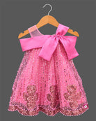 Girls sequin embellished A-line frock with large front satin bow, illusion mesh straps, and pearl beaded trim.