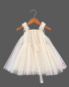 Cream Little Girl Tulle Party Frock with Polka Dots, Flower Details, and Square Neck on Hanger.