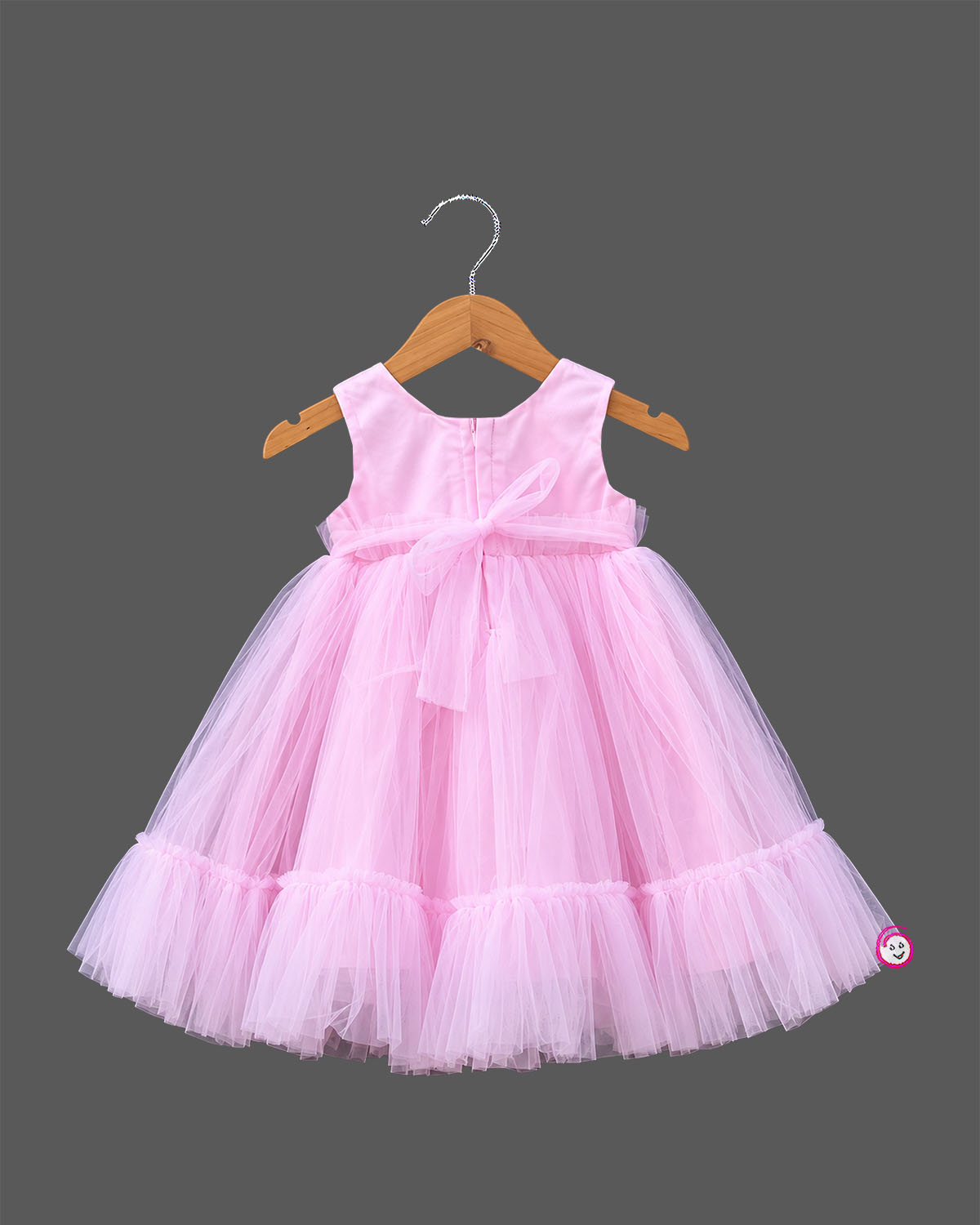 Little girl in soft pink net frock with floral appliqués and shimmer bodice for birthday parties