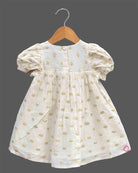 Little princess jacquard frock with front bow accent puff sleeves and woven circular motif detail
