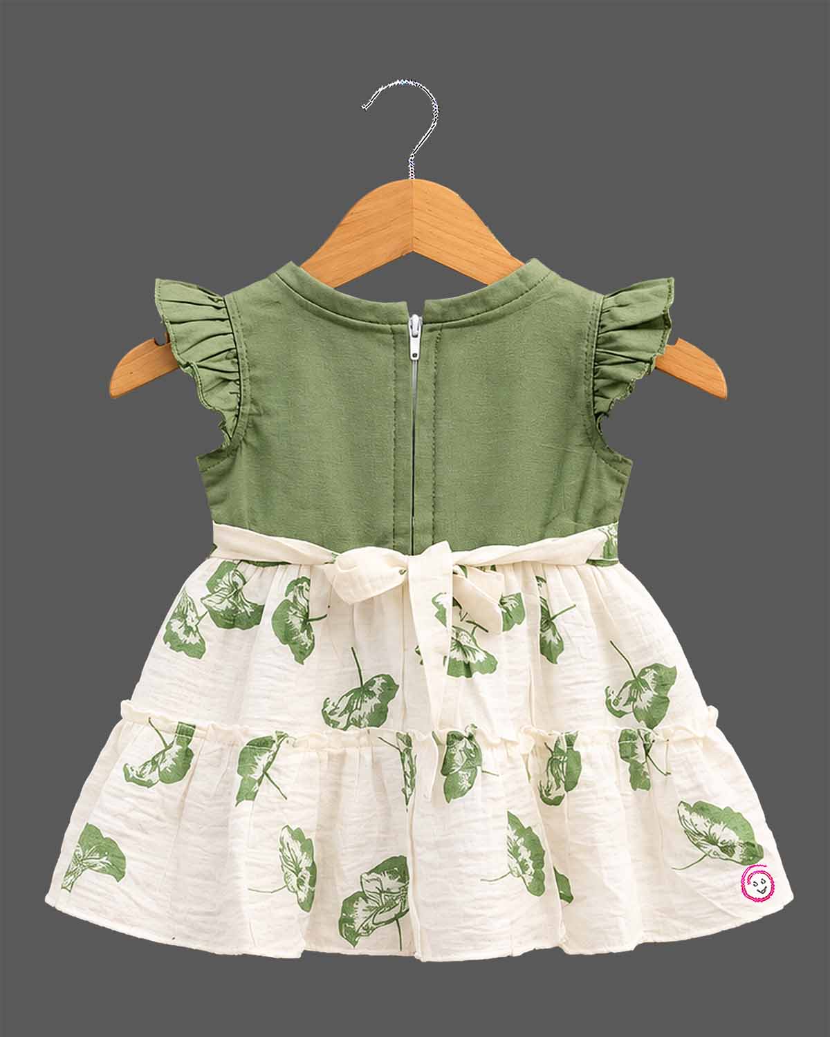Toddler girls tiered frock featuring ruffled flutter sleeves, a waist bow, and botanical leaf prints.
