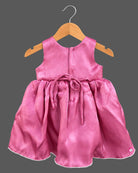 Sleeveless satin fit-and-flare dress with pearl rosette waist accents and baby party wear dress detail.