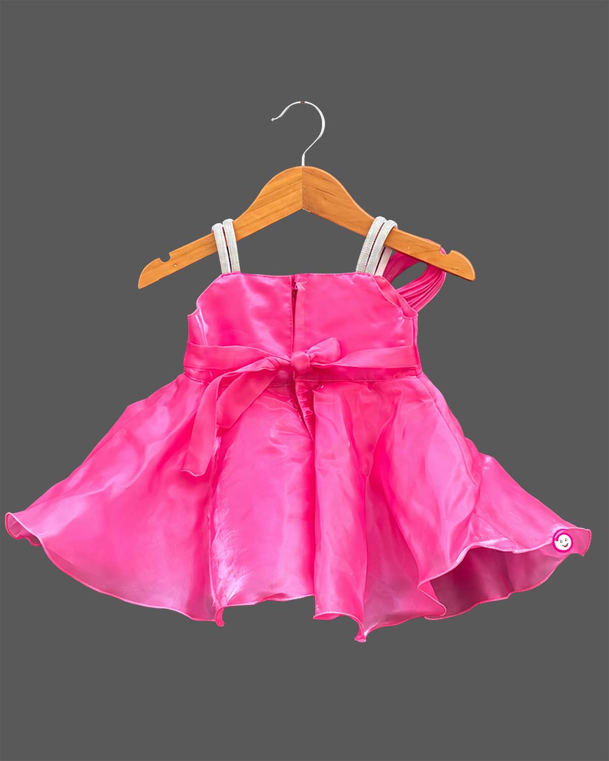 Girls organza party frock featuring oversized front bow appliqué and flared hem silhouette.