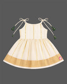 Little princess wearing woven traditional festive outfit featuring shoulder strap tassels and metallic woven trim.