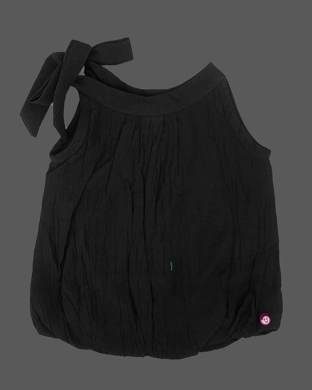 Girls tie shoulder sleeveless top with bow strap detail and charm accent, trendy girlish party wear dress alternative.