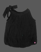 Girls tie shoulder sleeveless top with bow strap detail and charm accent, trendy girlish party wear dress alternative.