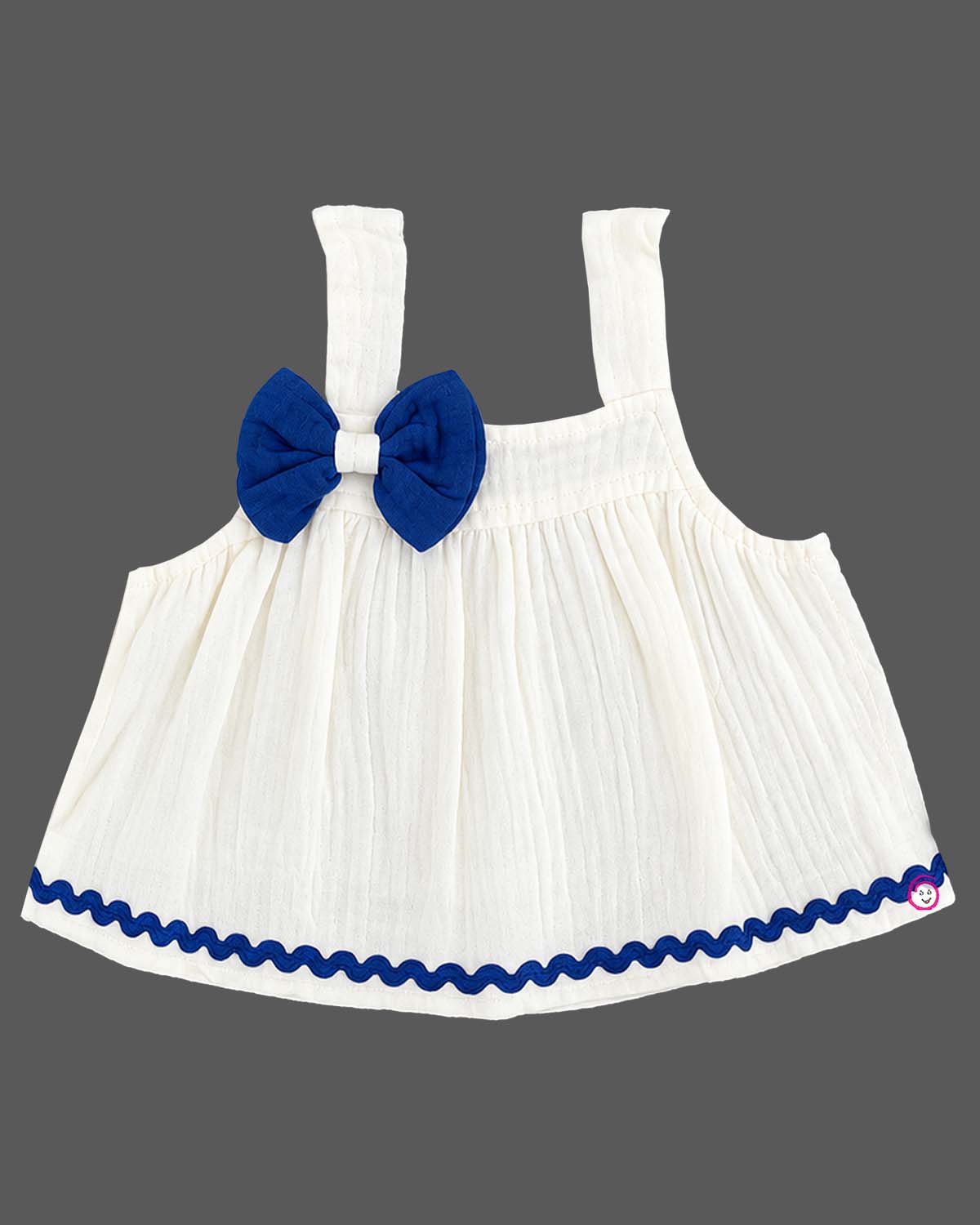 Sleeveless A-line top with decorative bow paired with wave-trimmed shorts.