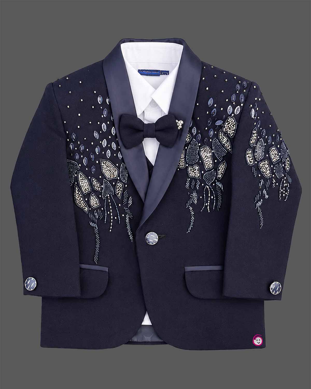 Boys formal tuxedo suit set featuring bead embellished blazer with bowtie and pant.
