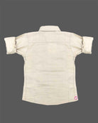 Sophisticated toddler boys button-up shirt featuring subtle micro-patterns with a small chest patch and roll-up sleeves.