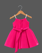 Hot pink satin party frock for girls with white and magenta floral rose appliques and embellished shoulder straps