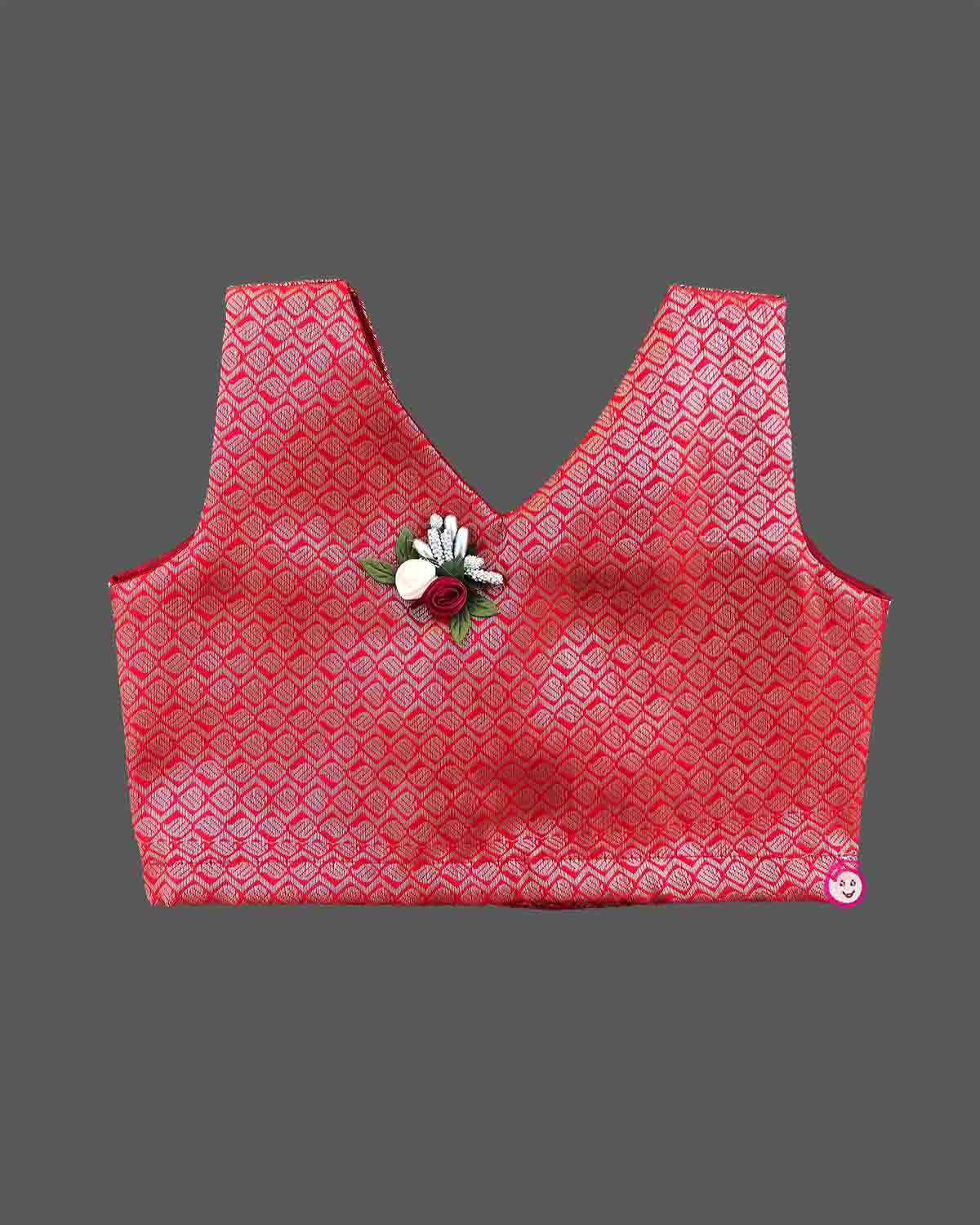 Kids festive wear featuring V neck jacquard blouse with floral brooch detail and zari pleated skirt set