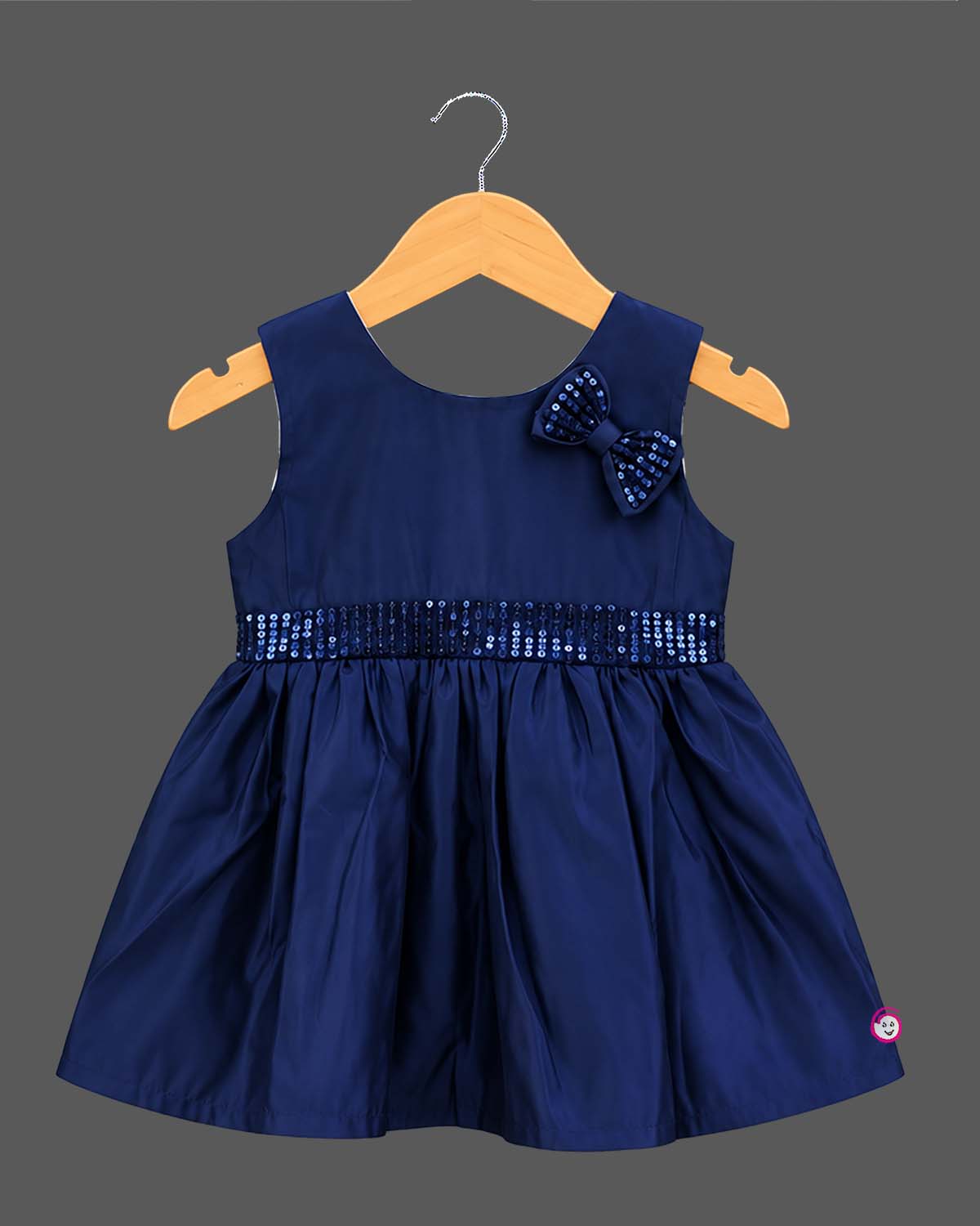 Sleeveless A-line frock with sequined waist belt and shoulder bow, styled as a baby casual wear dress.