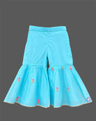 Girls sleeveless embroidered peplum kurti paired with tiered flared sharara pants featuring tassel ties.