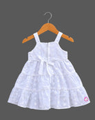 Sleeveless  tiered frock with decorative appliques and casual frock details.