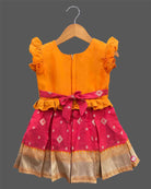 Traditional cotton silk ethnic frock for little ones featuring sequin work neckline ruffle sleeves and zari border