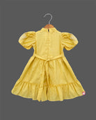 Infant yellow cotton frock with puff sleeves and tassels for family picnic