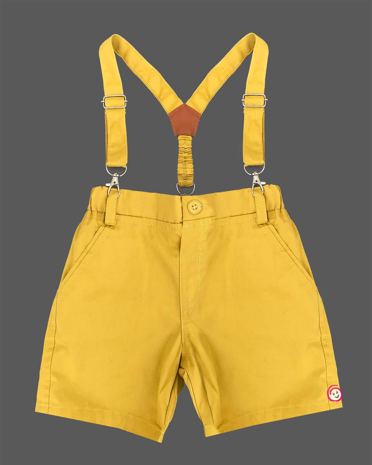 Playful toddler boys dapper outfit featuring a printed button-down shirt, cute bow tie, and matching suspender shorts.