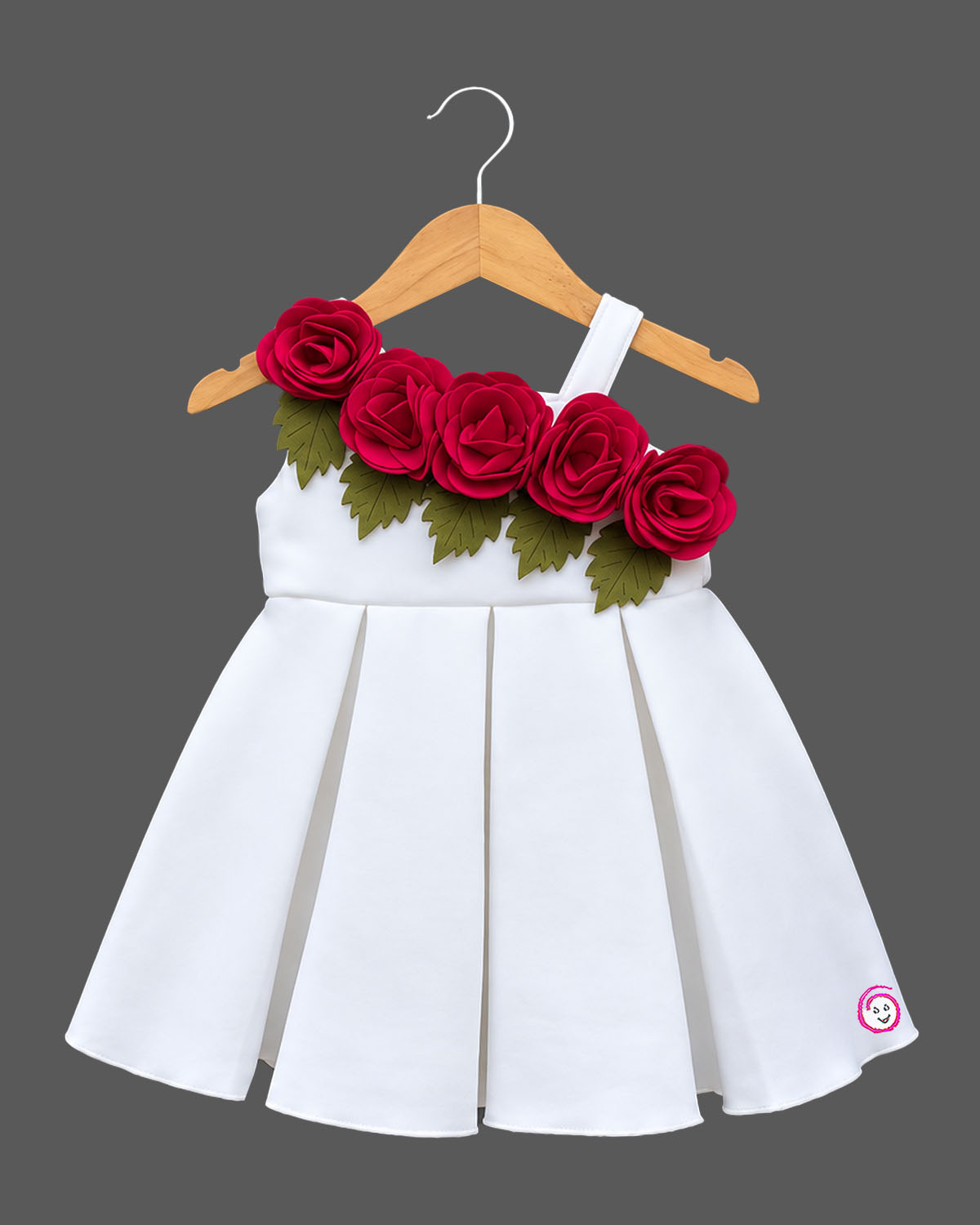 Baby girl scuba frock featuring structured box pleats and dimensional rose appliques for party wear