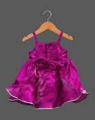 Toddler satin party frock featuring a sequined double bow and sleeveless strap design