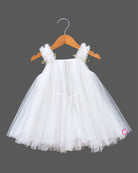 Off white net party frock with pink tulip floral accents and strap bows for girls