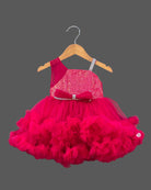 Sequined high-low baby party wear dress with layered tulle ruffle skirt and embellished strap.