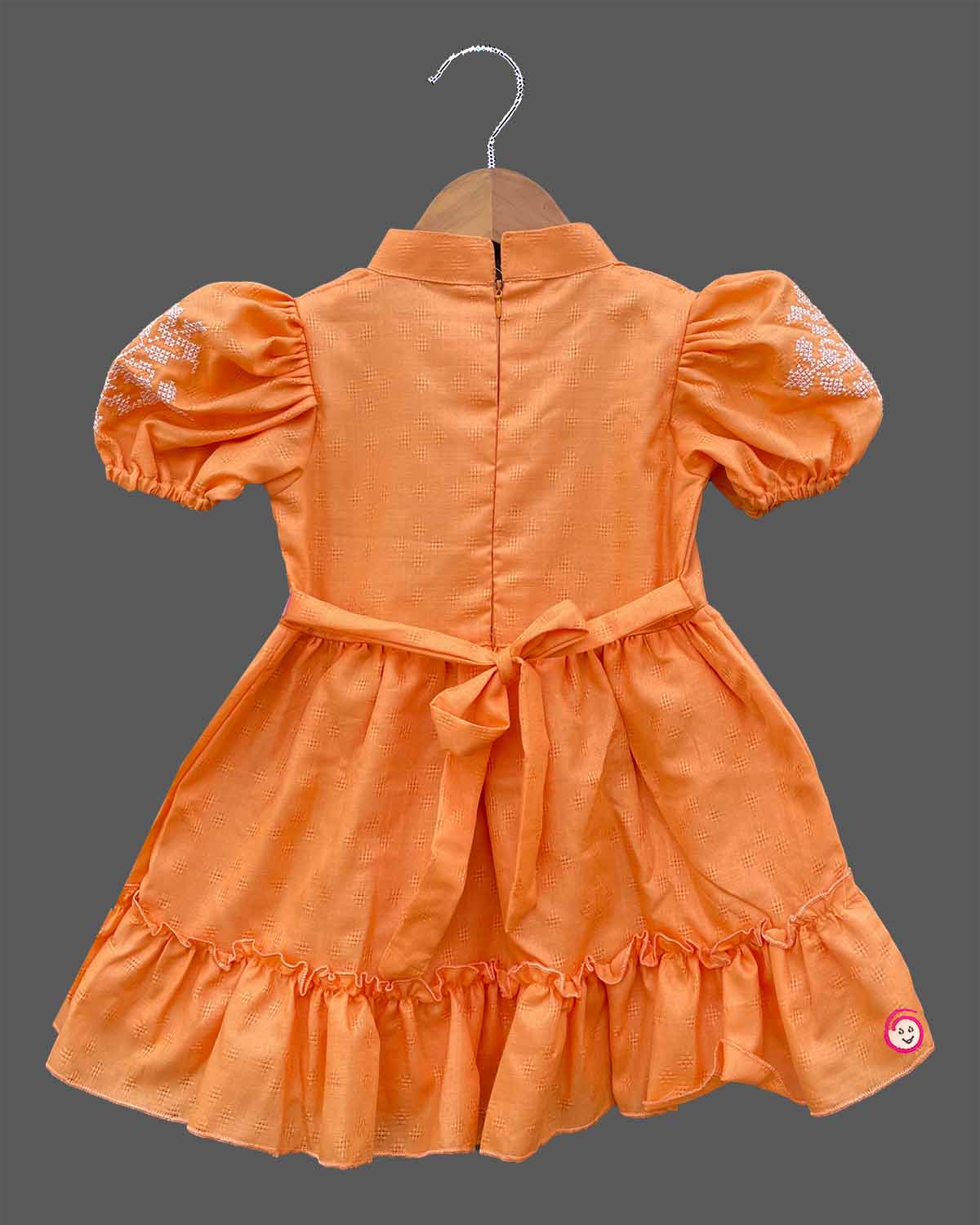 Orange cotton baby girl frock with puff sleeves and white embroidery detail