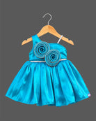 Silk frocks for baby girl with asymmetrical one-shoulder cut and beaded floral applique.
