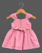 Toddler floral embroidered muslin frock with pleated cap shoulder straps and gathered A-line flared skirt.