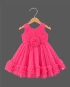 Sleeveless pleated tulle frock for girls with flower applique and ruffled hemline on hanger