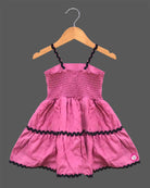 Toddler western frock with shoulder straps, scalloped wave trims, and a floral appliqué motif for celebrations and picnics.