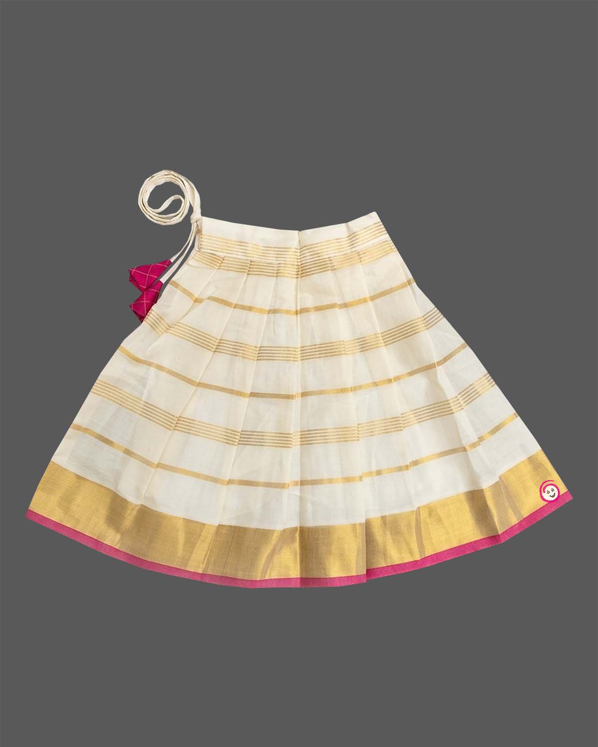 A sleeveless top with a checkered patch and a gold-striped skirt for Onam traditional wear.