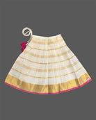 A sleeveless top with a checkered patch and a gold-striped skirt for Onam traditional wear.