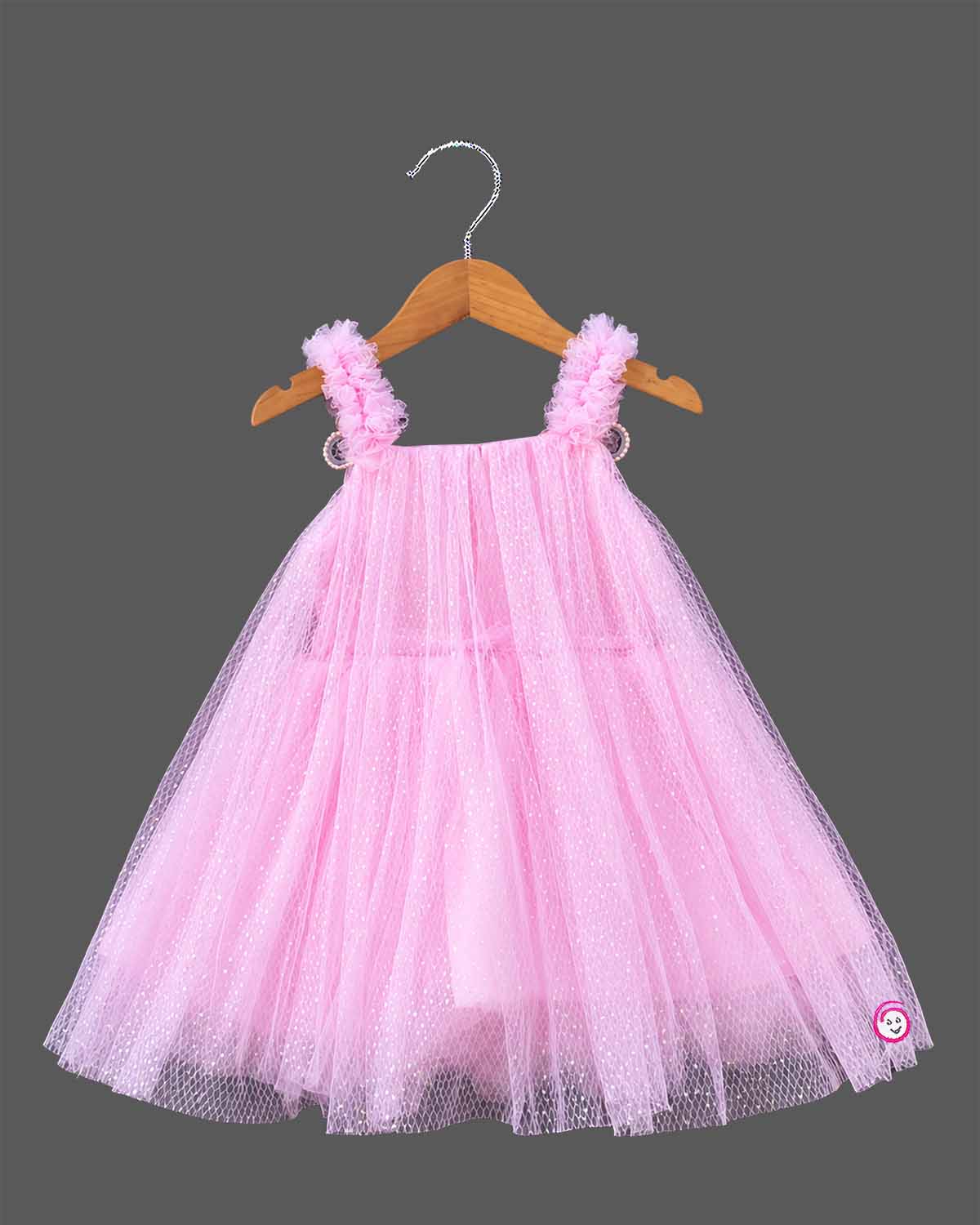 Little princess pink net frock with shimmer tulle overlay and floral shoulder embellishments for party wear