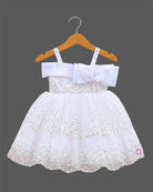 Girls sequined net frock with pearl embellished straps, satin bow with flower, and tiered scalloped flare skirt.