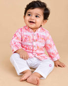 Baby boy wearing a mandarin collar printed kurta and elastic pyjama set for festive celebrations.