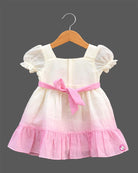 Toddler girls smocked bodice frock with puff sleeves, square neckline, and ric-rac trimmed ruffle hem.